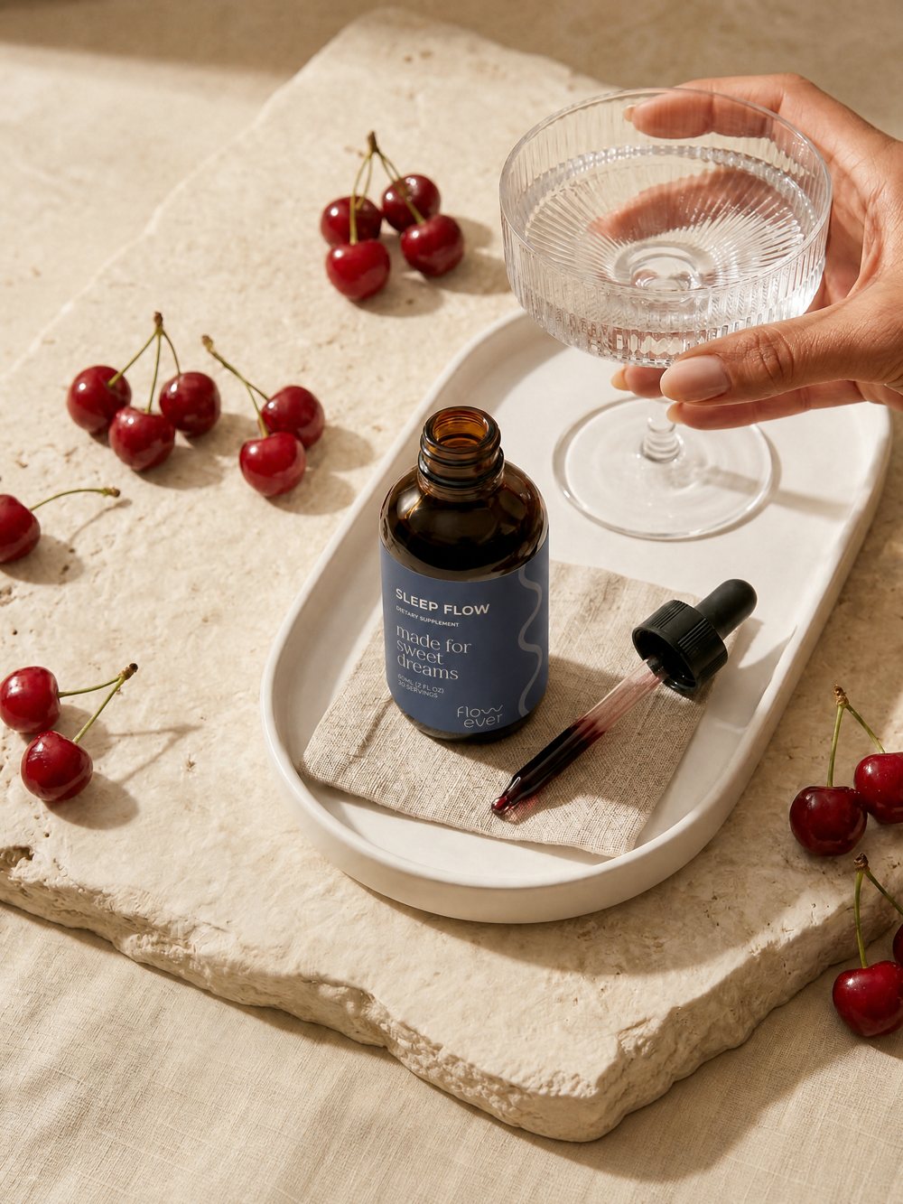 Sleep Flow on a stone tray with cherries and a glass of water